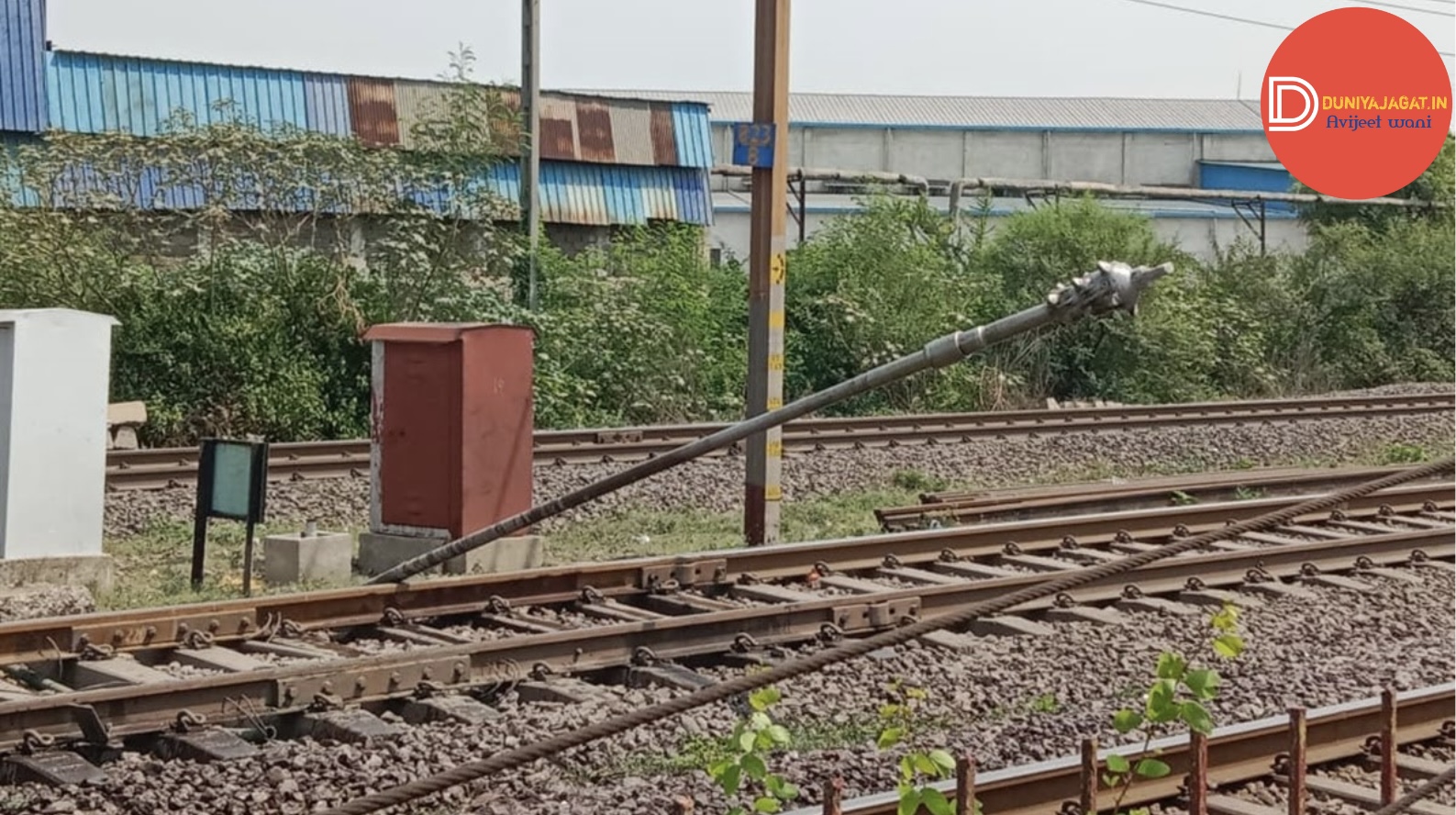 a pole on a pole next to a train track