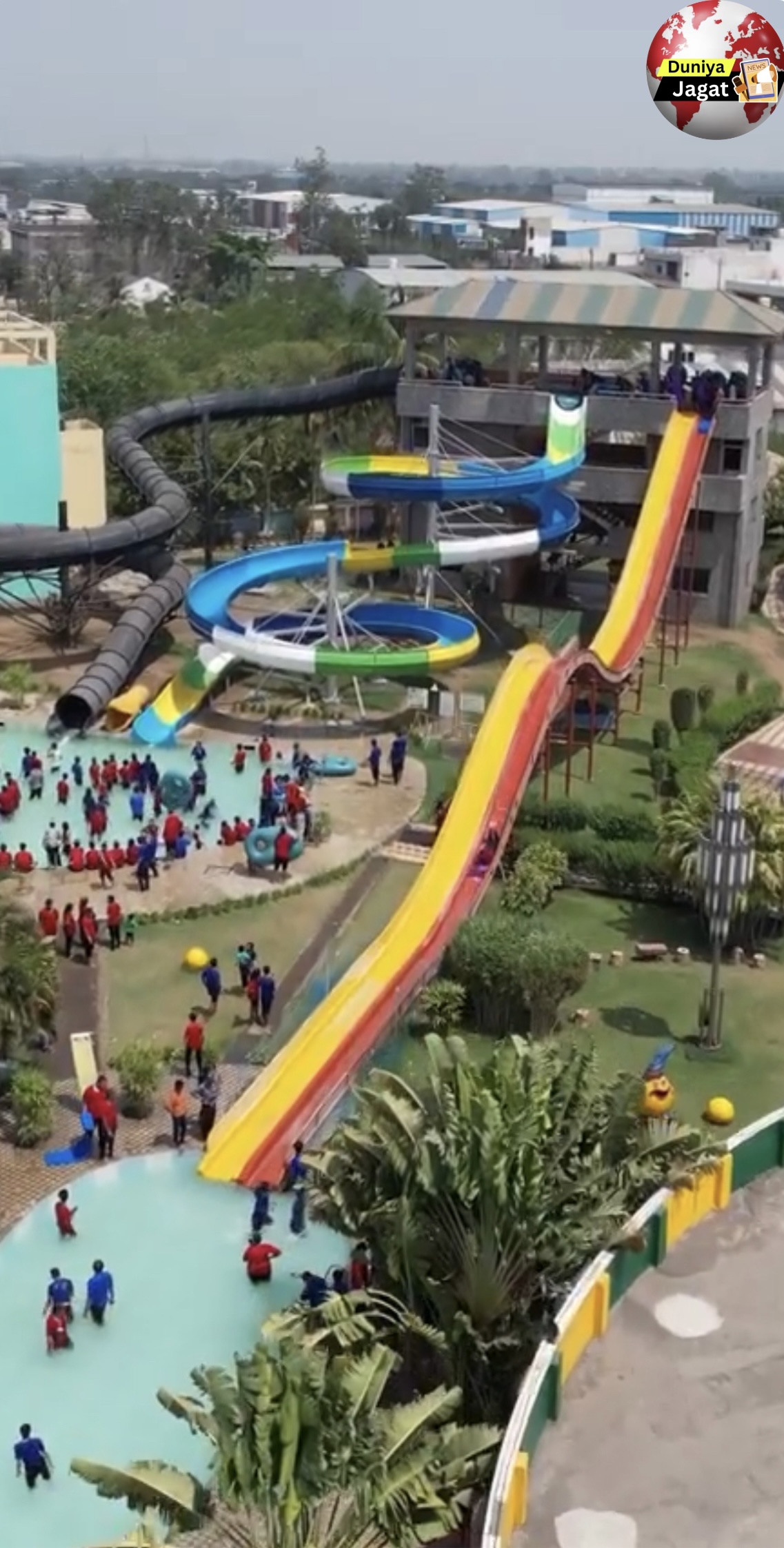 a water park with a slide and people around it